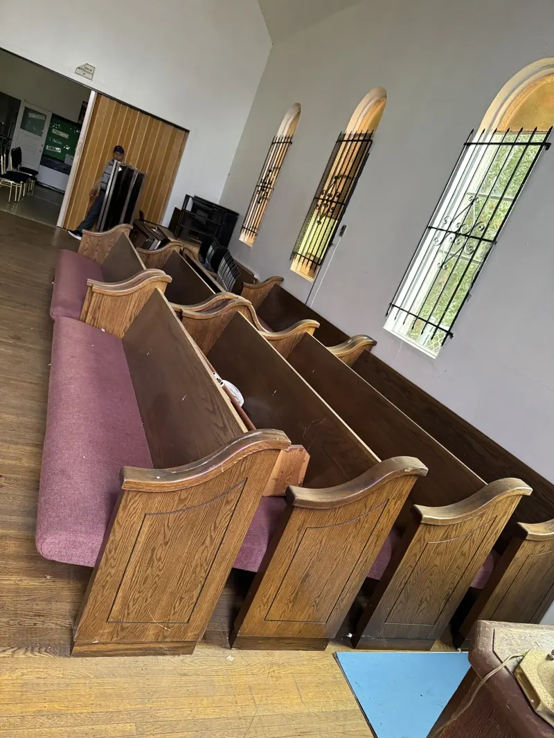 The original interior with church benches, before conversion