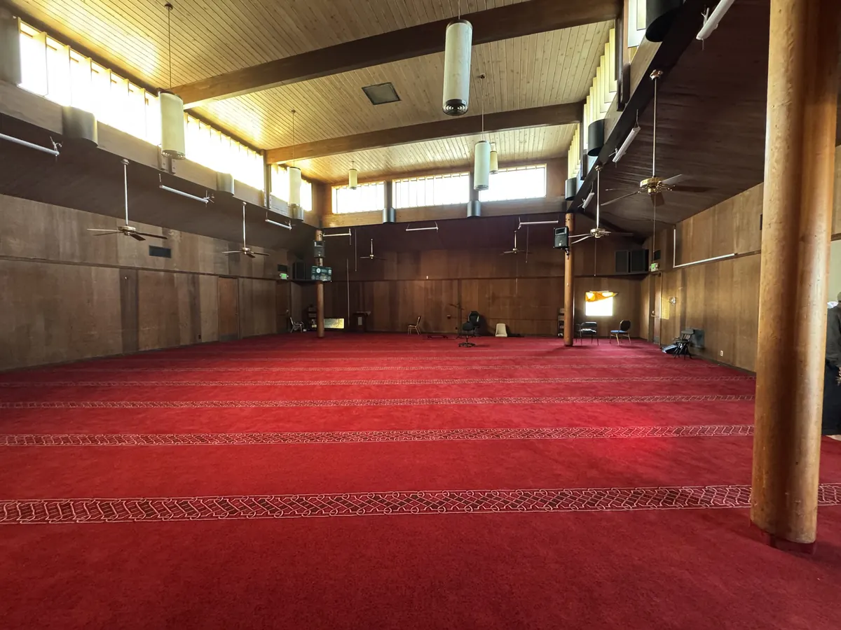 The active prayer hall today, with carpet laid and daily prayers held